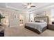 Spacious main bedroom with a ceiling fan, a sitting area, and a view into an ensuite bathroom at 2421 Trenton Park Ln, Raleigh, NC 27607