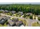 Neighborhood with lush green trees surrounding the homes; showcasing the peaceful community at 2421 Trenton Park Ln, Raleigh, NC 27607