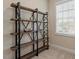 Stylish rustic shelving unit with metal accents and a variety of decorative objects and books at 2421 Trenton Park Ln, Raleigh, NC 27607