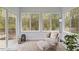 Bright sunroom filled with natural light from large windows and features stylish seating and decor at 2421 Trenton Park Ln, Raleigh, NC 27607