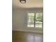 Bedroom featuring hardwood floors, a ceiling light, and large window with neighborhood views at 245 Marilyn Cir, Cary, NC 27513