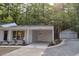 Exterior shows the house and a detached two-car garage. The property is surrounded by lush green trees at 245 Marilyn Cir, Cary, NC 27513