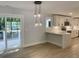 An open concept kitchen with recessed lights, pendant lights, wood floors, white cabinets, and stainless-steel appliances at 245 Marilyn Cir, Cary, NC 27513