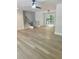 A large living room with wood floors, gray walls, modern stair railing, and a glass patio door that leads to a deck at 245 Marilyn Cir, Cary, NC 27513
