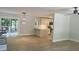 Open-concept living room and kitchen with light gray walls, wood floors, modern lighting, and glass patio doors at 245 Marilyn Cir, Cary, NC 27513