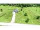 Aerial shot of a single-Gathering home with a driveway and a big manicured yard surrounded by grassy fields at 2540 Levi Ln, Bahama, NC 27503