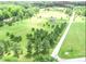 Wide aerial perspective showcasing a house surrounded by green fields and forest, providing a private setting at 2540 Levi Ln, Bahama, NC 27503