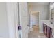 Bathroom with double vanity, walk-in closet, and wood-look flooring at 2540 Levi Ln, Bahama, NC 27503
