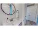 Modern powder room with stylish round mirror, a vessel sink, wood-look flooring, and decor at 2540 Levi Ln, Bahama, NC 27503