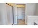 Bathroom featuring a walk-in closet with shelving and carpet, and a shower with glass door at 2540 Levi Ln, Bahama, NC 27503