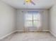 Bright bedroom with a ceiling fan, neutral tones, and natural light streaming through a large window at 2540 Levi Ln, Bahama, NC 27503