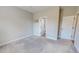 Clean carpeted bedroom featuring neutral walls and a doorway that leads to a bathroom at 2540 Levi Ln, Bahama, NC 27503
