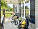 Inviting front porch with rocking chairs and a swing, perfect for relaxing and enjoying the outdoors at 2540 Levi Ln, Bahama, NC 27503