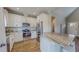 Modern kitchen features white cabinetry, stainless appliances, a granite island, and hardwood floors at 2540 Levi Ln, Bahama, NC 27503