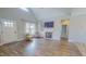 Open concept living room featuring vaulted ceilings, fireplace and luxury vinyl plank flooring at 2540 Levi Ln, Bahama, NC 27503