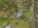 Aerial shot shows the home's location with a large lot, garden, trees, garage, outdoor kitchen, and fire pit at 2920 Ode Turner Rd, Hillsborough, NC 27278