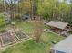 A sprawling lot features a spacious backyard, garden, garage, outdoor kitchen, fire pit, and ample greenspace at 2920 Ode Turner Rd, Hillsborough, NC 27278