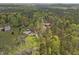Aerial view of the property shows the house among the trees in a secluded, lush, wooded area at 2920 Ode Turner Rd, Hillsborough, NC 27278