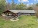 A well-maintained backyard boasts an outdoor kitchen with an inviting fire pit and a comfortable entertainment area at 2920 Ode Turner Rd, Hillsborough, NC 27278