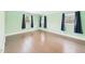 Bright bedroom featuring hardwood floors, paint, and several windows at 2920 Ode Turner Rd, Hillsborough, NC 27278