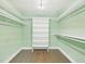 Walk in closet with built-in shelving and rods for clothing and storage at 2920 Ode Turner Rd, Hillsborough, NC 27278