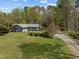 Lovely single-story home nestled among mature trees on a sprawling green lawn in a private setting at 2920 Ode Turner Rd, Hillsborough, NC 27278