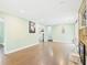 Sun-filled living room with hardwood floors, light-colored walls, and access to other rooms at 2920 Ode Turner Rd, Hillsborough, NC 27278