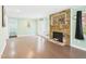 Open-concept living room featuring light-colored walls, hardwood floors, and a stone fireplace at 2920 Ode Turner Rd, Hillsborough, NC 27278