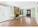 Spacious living room with hardwood flooring, mint-colored walls, and stone fireplace at 2920 Ode Turner Rd, Hillsborough, NC 27278