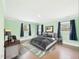 Staged primary bedroom with hardwood floors and double windows for natural light at 2920 Ode Turner Rd, Hillsborough, NC 27278