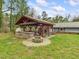 Outdoor entertainment area featuring a built-in kitchen, wood burning fireplace, and seating at 2920 Ode Turner Rd, Hillsborough, NC 27278