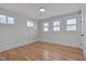 Bright bedroom with hardwood floors, white trim, and multiple windows at 301 E Umstead St, Durham, NC 27707
