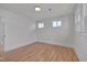 Bright bedroom featuring hardwood floors and multiple windows for ample natural light at 301 E Umstead St, Durham, NC 27707