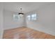 Minimalist bedroom design with chandelier and hardwood floors at 301 E Umstead St, Durham, NC 27707