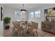 Dining room features stylish chandelier, dining table set, and large windows with natural light at 301 E Umstead St, Durham, NC 27707
