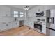 Modern kitchen with white cabinets, stainless steel appliances, and subway tile backsplash at 301 E Umstead St, Durham, NC 27707