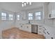 Modern kitchen features white cabinets, stainless steel appliances, and a subway tile backsplash at 301 E Umstead St, Durham, NC 27707