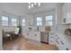Bright kitchen featuring white cabinets, stainless steel appliances, and an adjacent breakfast nook at 301 E Umstead St, Durham, NC 27707