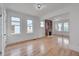 Spacious living room featuring a brick fireplace, large windows, and hardwood floors at 301 E Umstead St, Durham, NC 27707