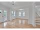 Bright and airy living room featuring hardwood floors, large windows, and modern lighting fixtures at 301 E Umstead St, Durham, NC 27707