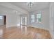 Inviting living room with hardwood floors, fresh white paint, and a bright white front door at 301 E Umstead St, Durham, NC 27707
