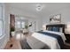 Bright main bedroom features hardwood floors, a sitting area and modern chandelier at 301 E Umstead St, Durham, NC 27707