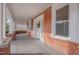 Wide porch featuring classic columns and brick accents, offering a tranquil spot to unwind and enjoy the surroundings at 301 E Umstead St, Durham, NC 27707