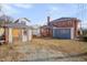 A large two-story brick home with a new addition, a shed, and a small gravel backyard is pictured at 301 E Umstead St, Durham, NC 27707