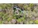 Aerial view of sprawling estate home surrounded by trees in full spring bloom at 301 Stone Currie Dr, Hillsborough, NC 27278