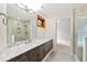 Bathroom vanity with marble countertop, under cabinet storage, and walk-in shower at 301 Stone Currie Dr, Hillsborough, NC 27278