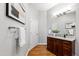 Well-lit bathroom featuring a dark wood vanity with granite countertops and framed mirror at 301 Stone Currie Dr, Hillsborough, NC 27278