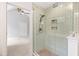 This luxurious bathroom has a glass shower with light blue tile and an opening into the carpeted bedroom at 301 Stone Currie Dr, Hillsborough, NC 27278