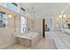 Contemporary bathroom with glass shower, soaking tub, white vanity and large window at 301 Stone Currie Dr, Hillsborough, NC 27278