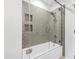 Modern bathroom features a tub and shower with green subway tile and a glass door at 301 Stone Currie Dr, Hillsborough, NC 27278